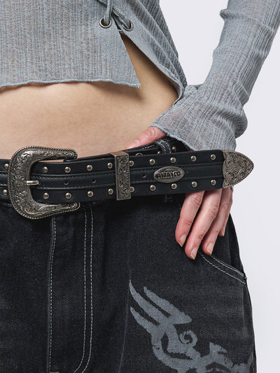 Black studded belt with an antique silver western-style buckle.