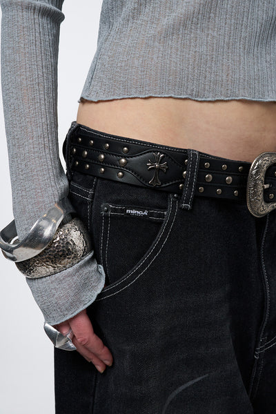 Black studded belt with an antique silver western-style buckle.