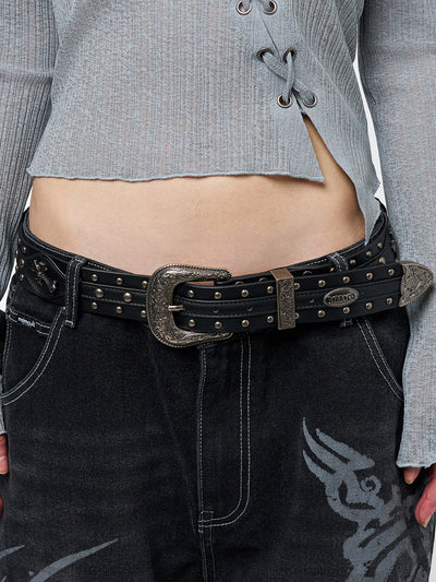 Black studded belt with an antique silver western-style buckle.