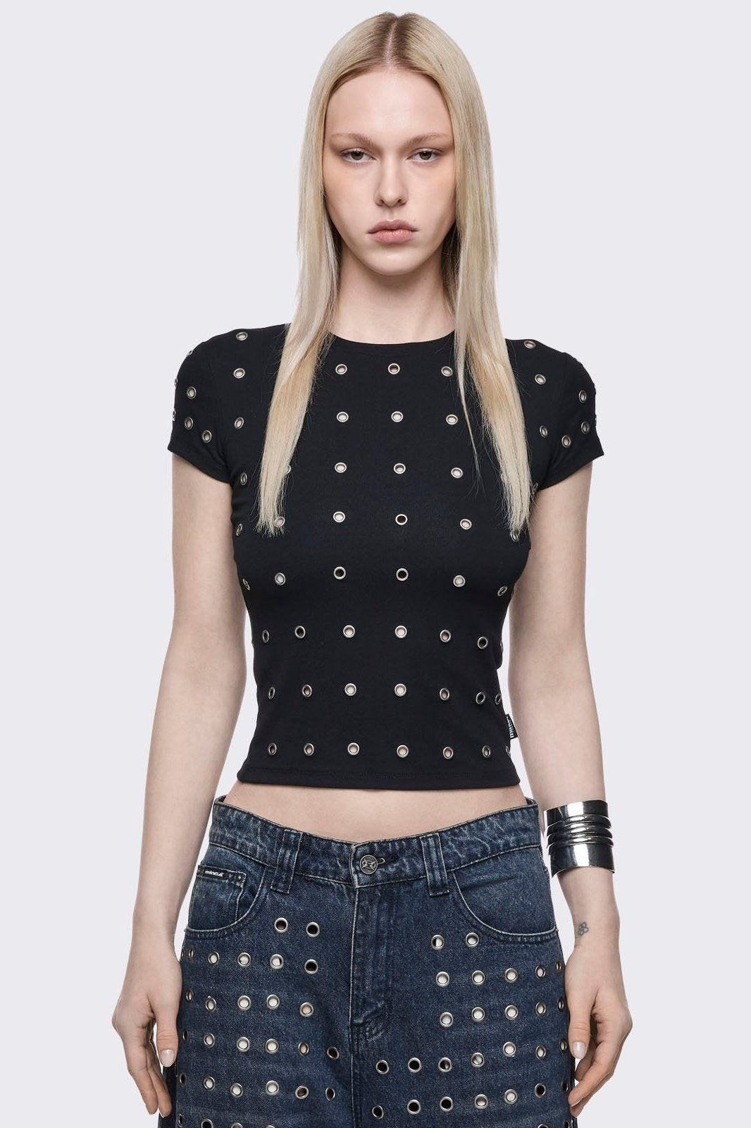 Black baby tee with silver eyelets. 