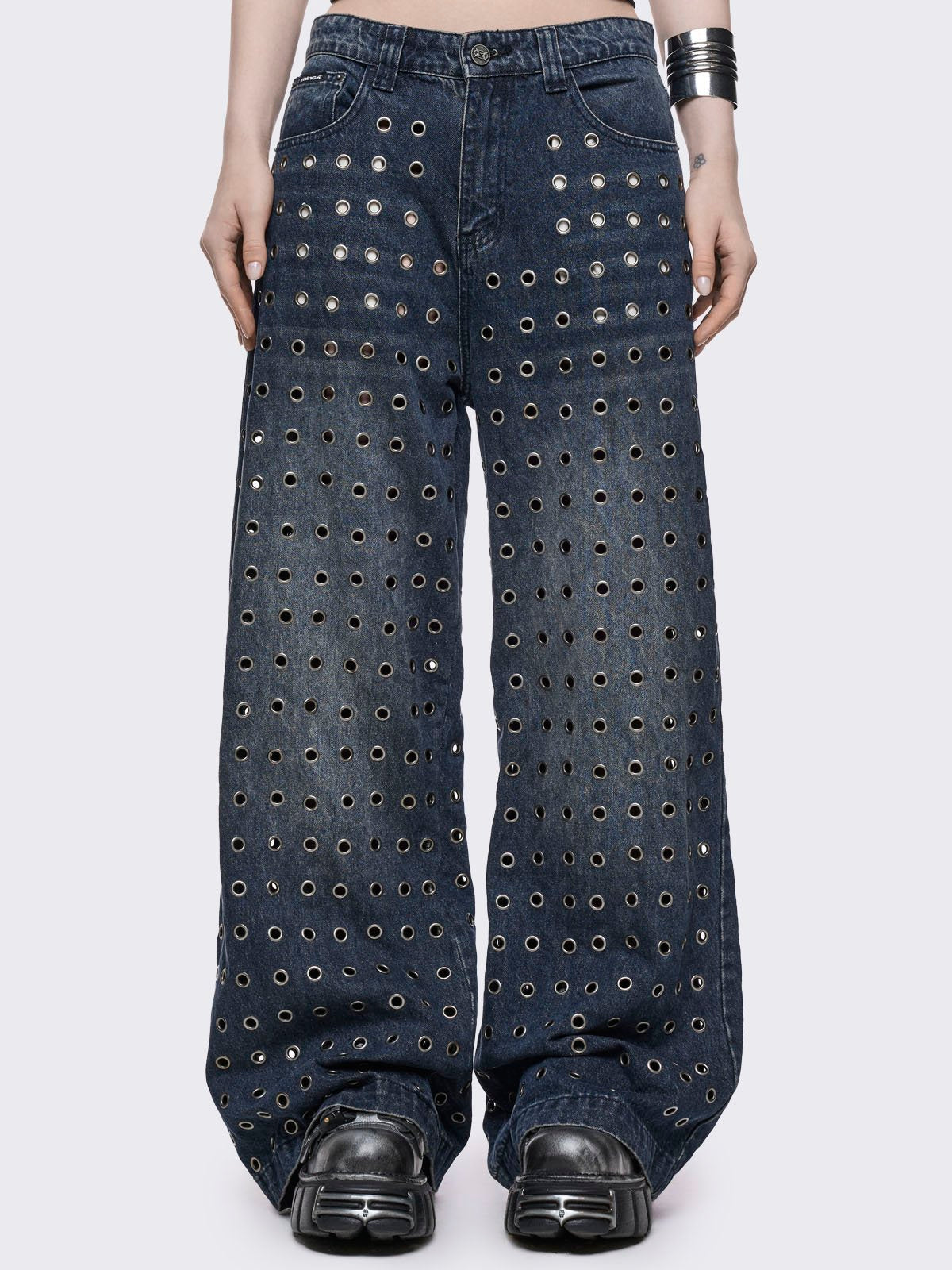 Blue washed baggy jeans with all over silver eyelets. 