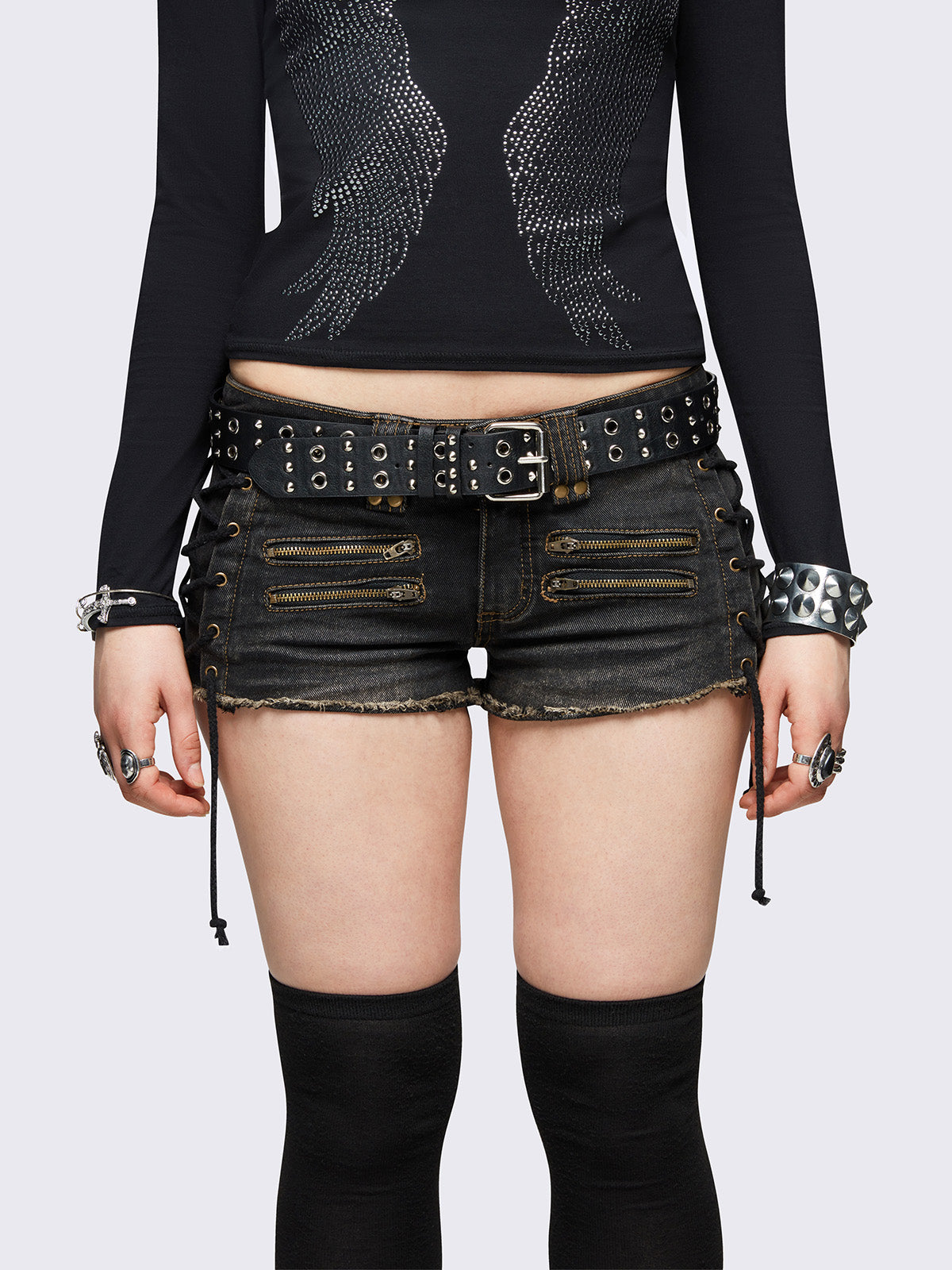 Black washed denim hot pants shorts featuring adjustable lace-up sides and double zip front details.