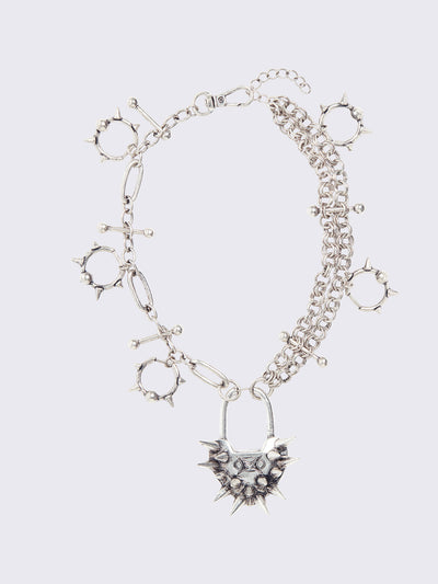 Chunky charm necklace with Spiked heart lock pendant and bold metal piercings details. 