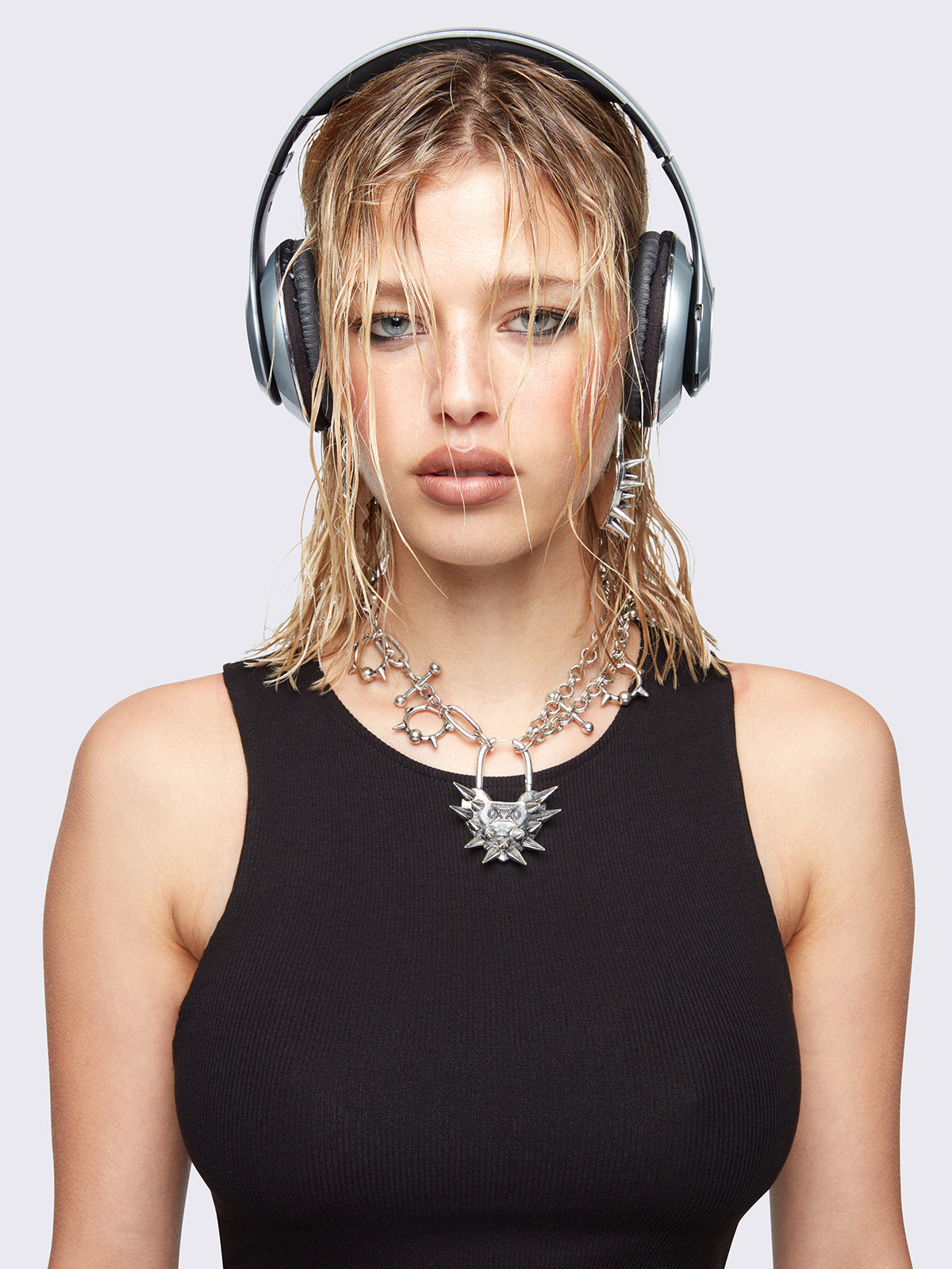 Chunky charm necklace with Spiked heart lock pendant and bold metal piercings details. 