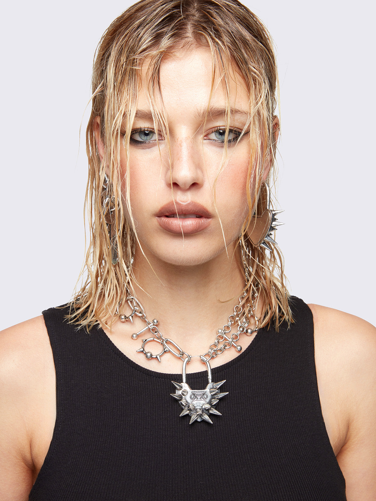 Chunky charm necklace with Spiked heart lock pendant and bold metal piercings details. 