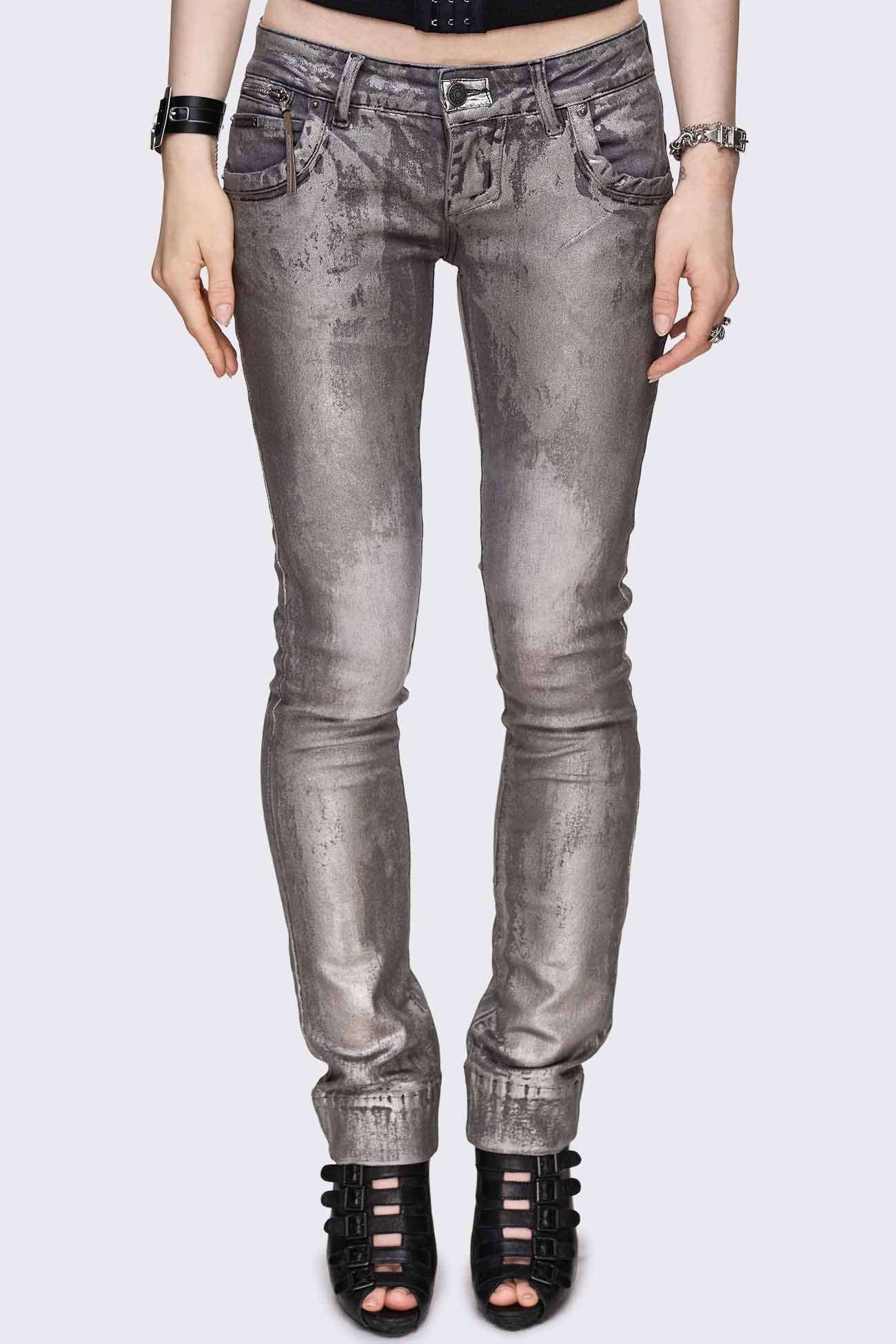 Grey skinny jeans with distressed metallic foil coated finish, low-rise waist and front zip pocket detail.