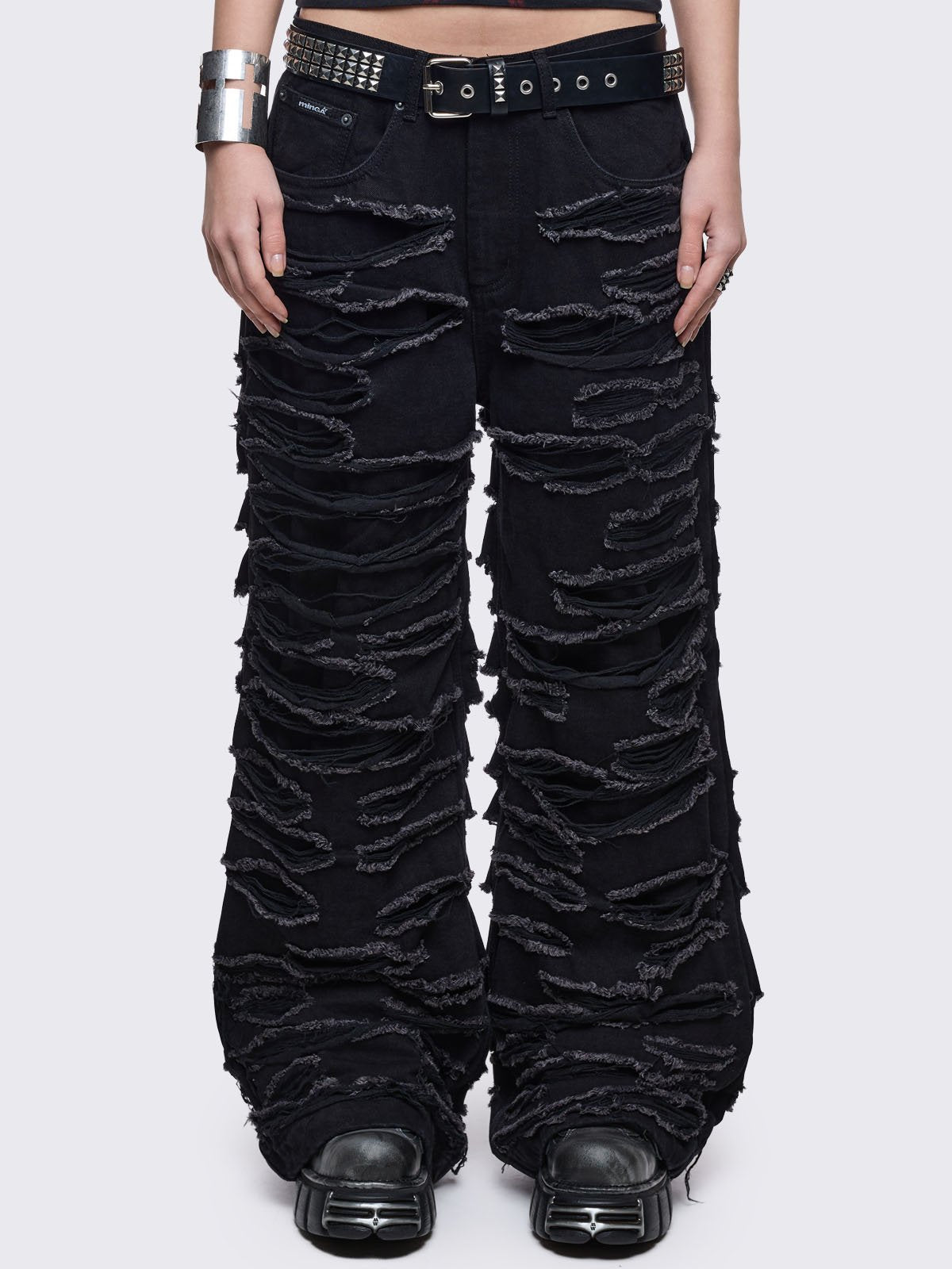 Black baggy jeans featuring distressed cut-out slashed legs.