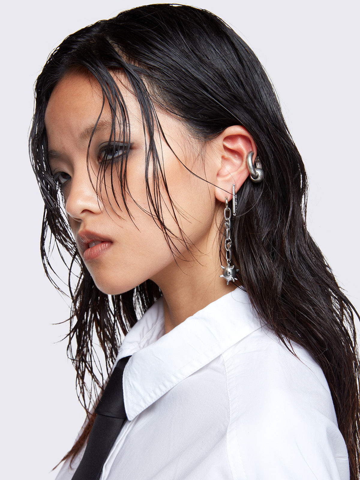 Silver 3pc earring set, one with Spiked ball pendant a razor blade and a dangle and hoop style. 