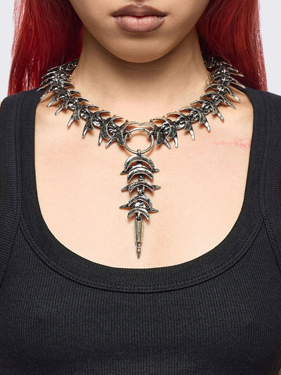 Silver chunky charm necklace featuring a spine design and spike pendant.