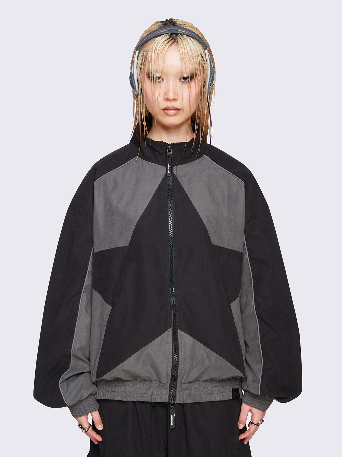 Black and grey color-block windbreaker with bold star graphic and oversized boxy fit— edgy, utility-inspired streetwear style.