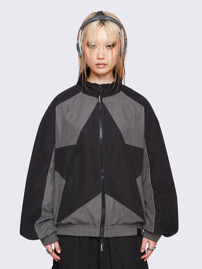 Black and grey color-block windbreaker with bold star graphic and oversized boxy fit— edgy, utility-inspired streetwear style.