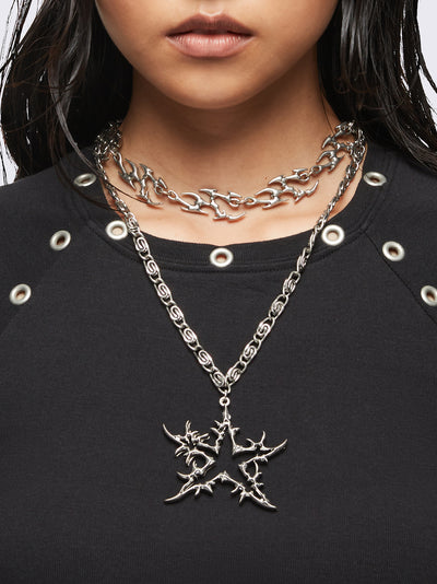 Set of 2 silver necklaces: A chunky chain with multiple sigilism charms and other with a star pendant.