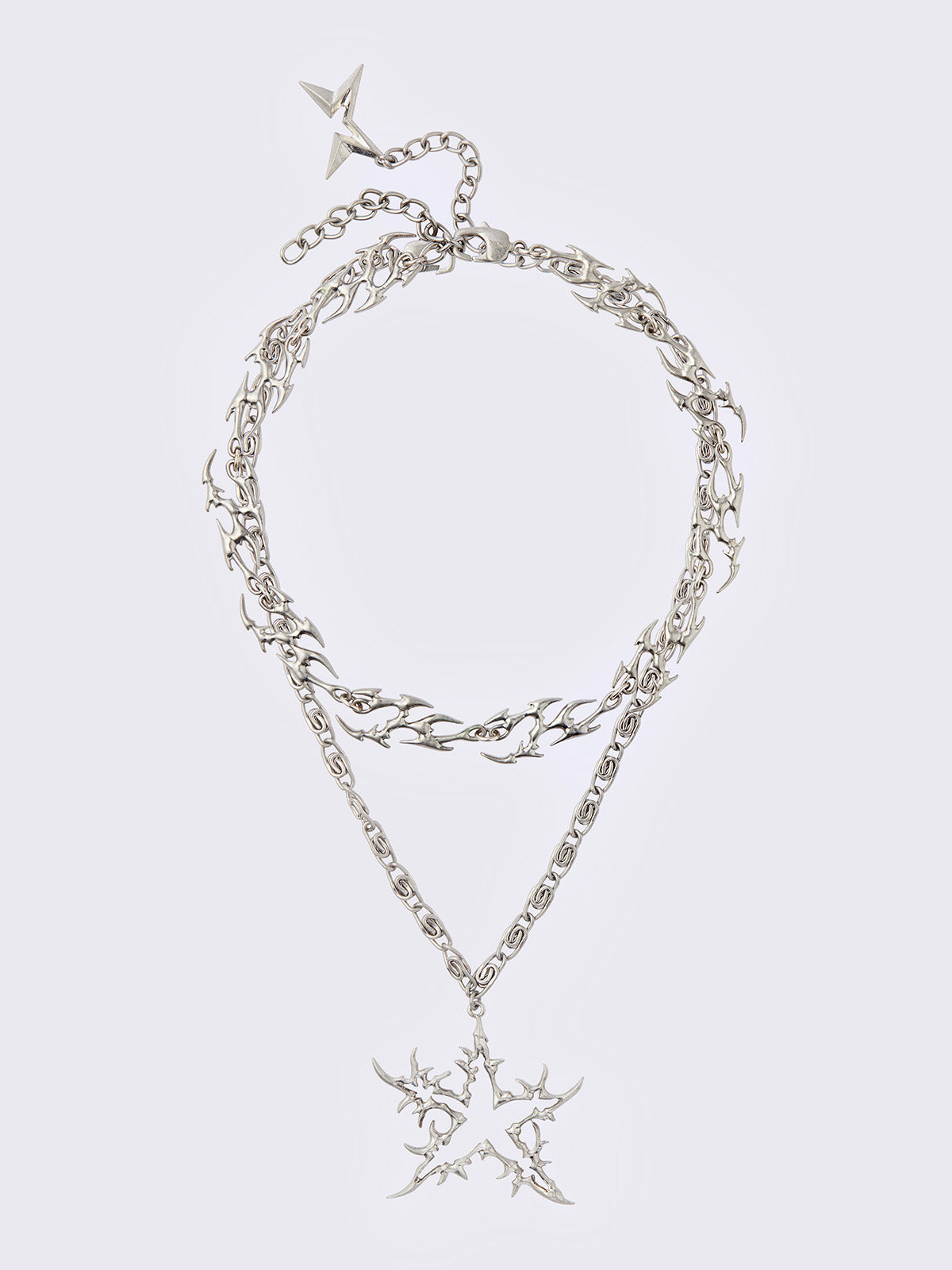 Set of 2 silver necklaces: A chunky chain with multiple sigilism charms and other with a star pendant.