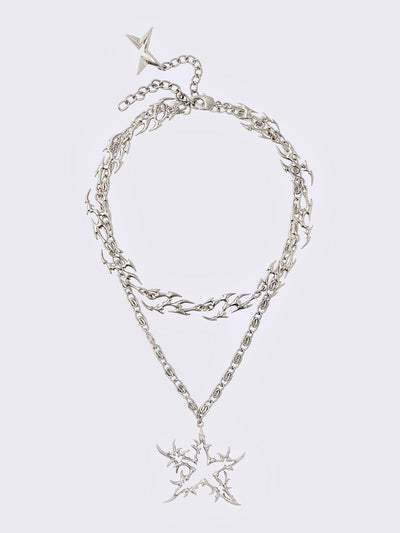 Set of 2 silver necklaces: A chunky chain with multiple sigilism charms and other with a star pendant.