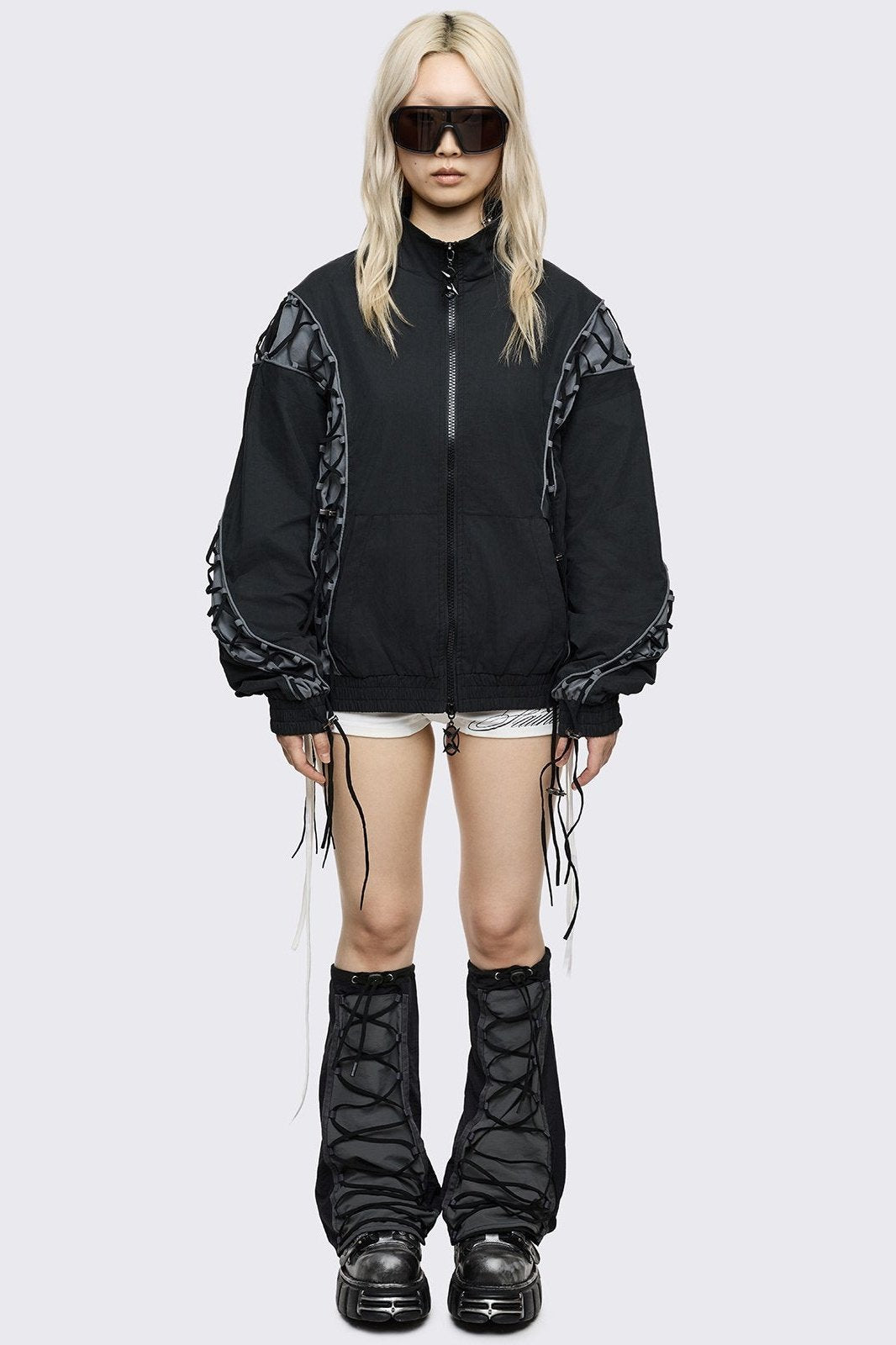 Black tech flared leg warmers with grey panel with lace-up and adjustable toggle