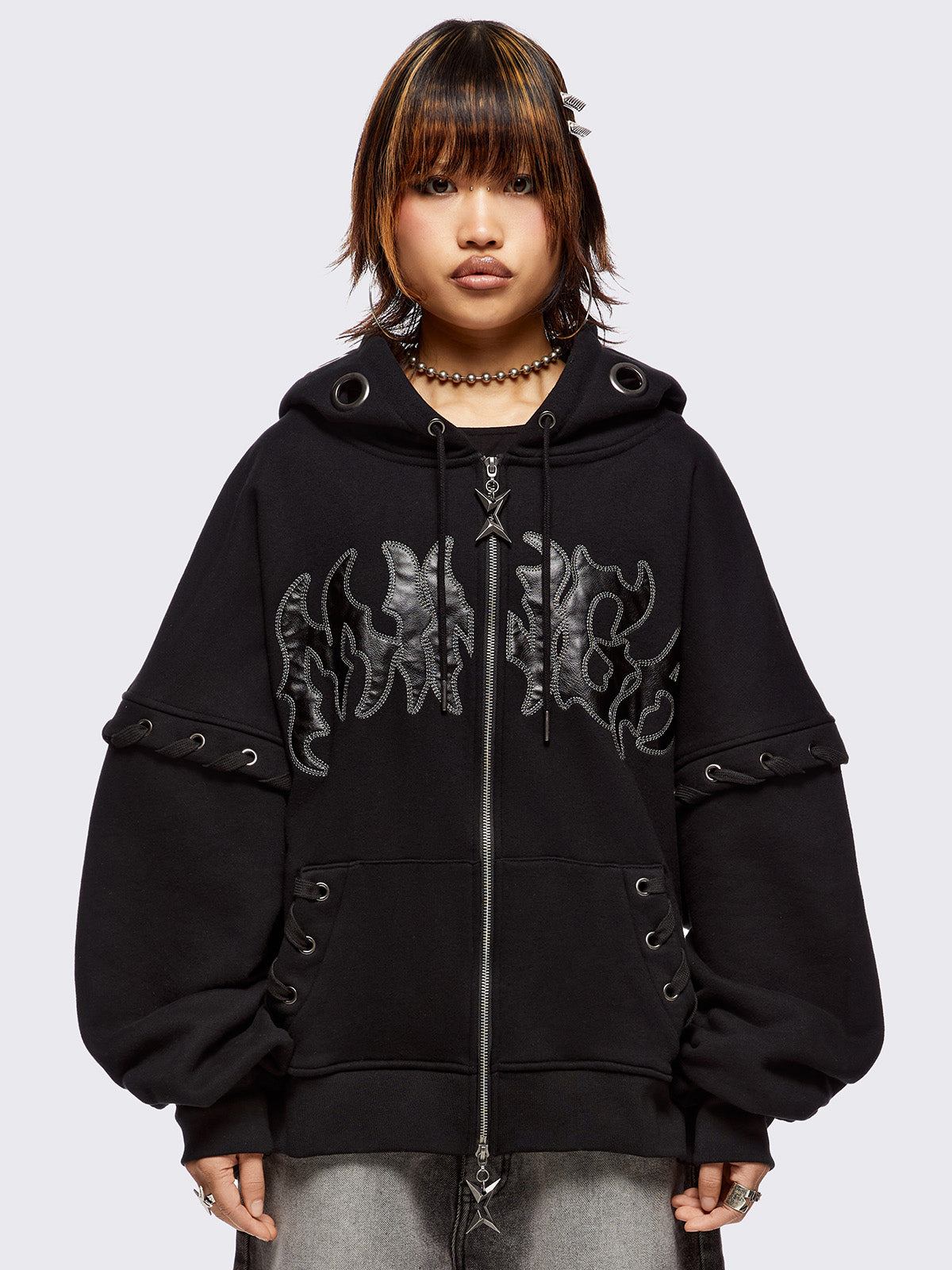 Black layered zip up hoodie with Minga patch in PU and chunky eyelets on hood and lace up details.