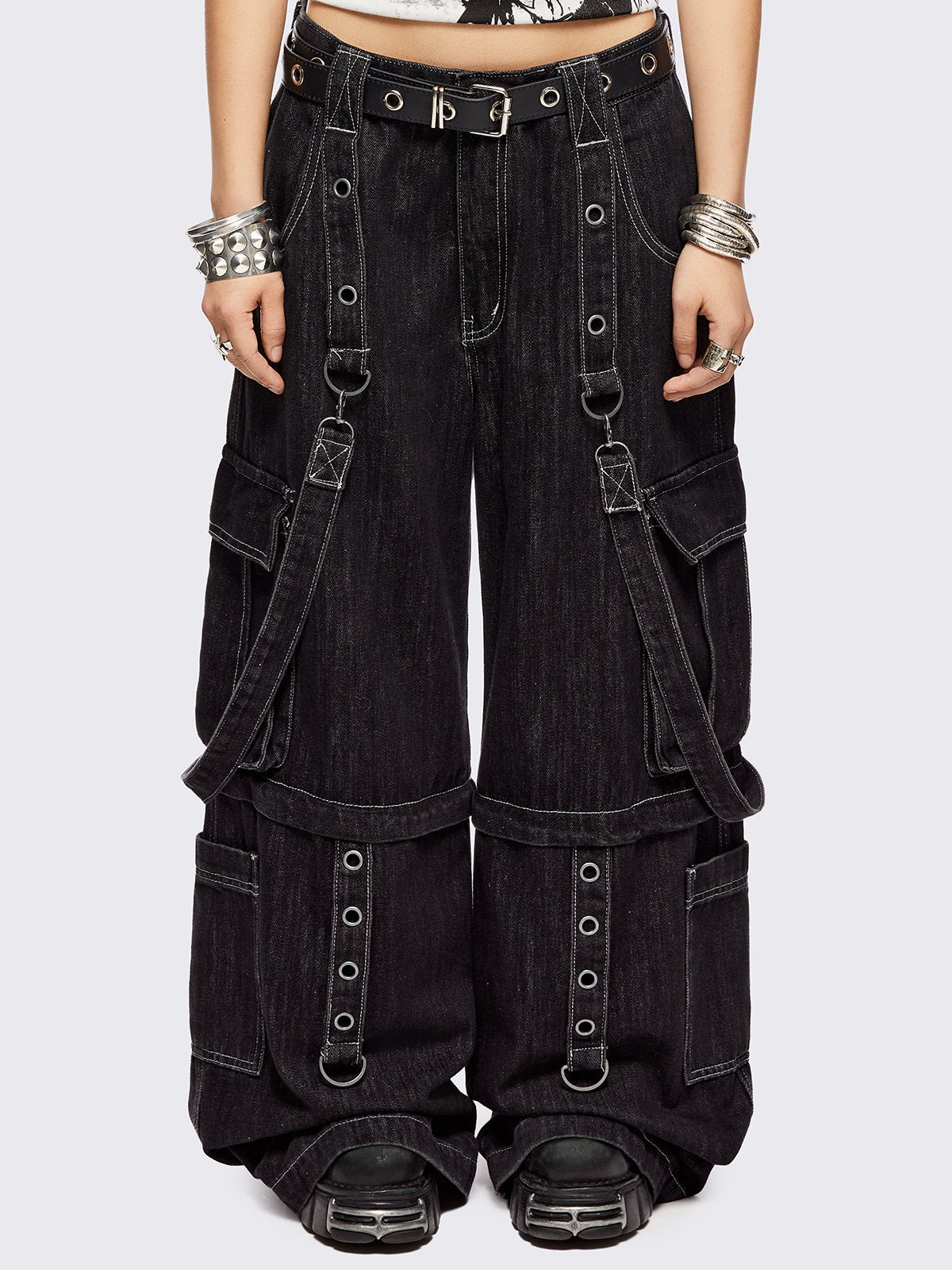 Black multi pocket cargo jeans featuring a detachable-leg with zipper and all over straps and D-rings details.