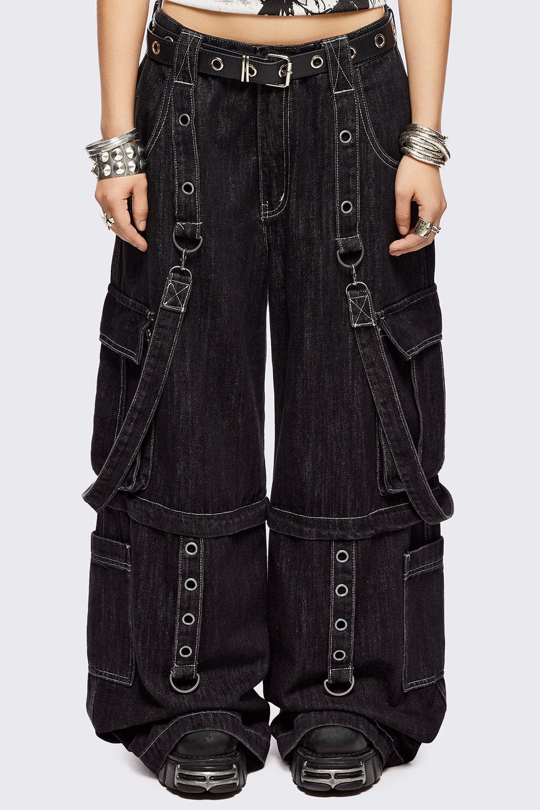 Black multi pocket cargo jeans featuring a detachable-leg with zipper and all over straps and D-rings details.