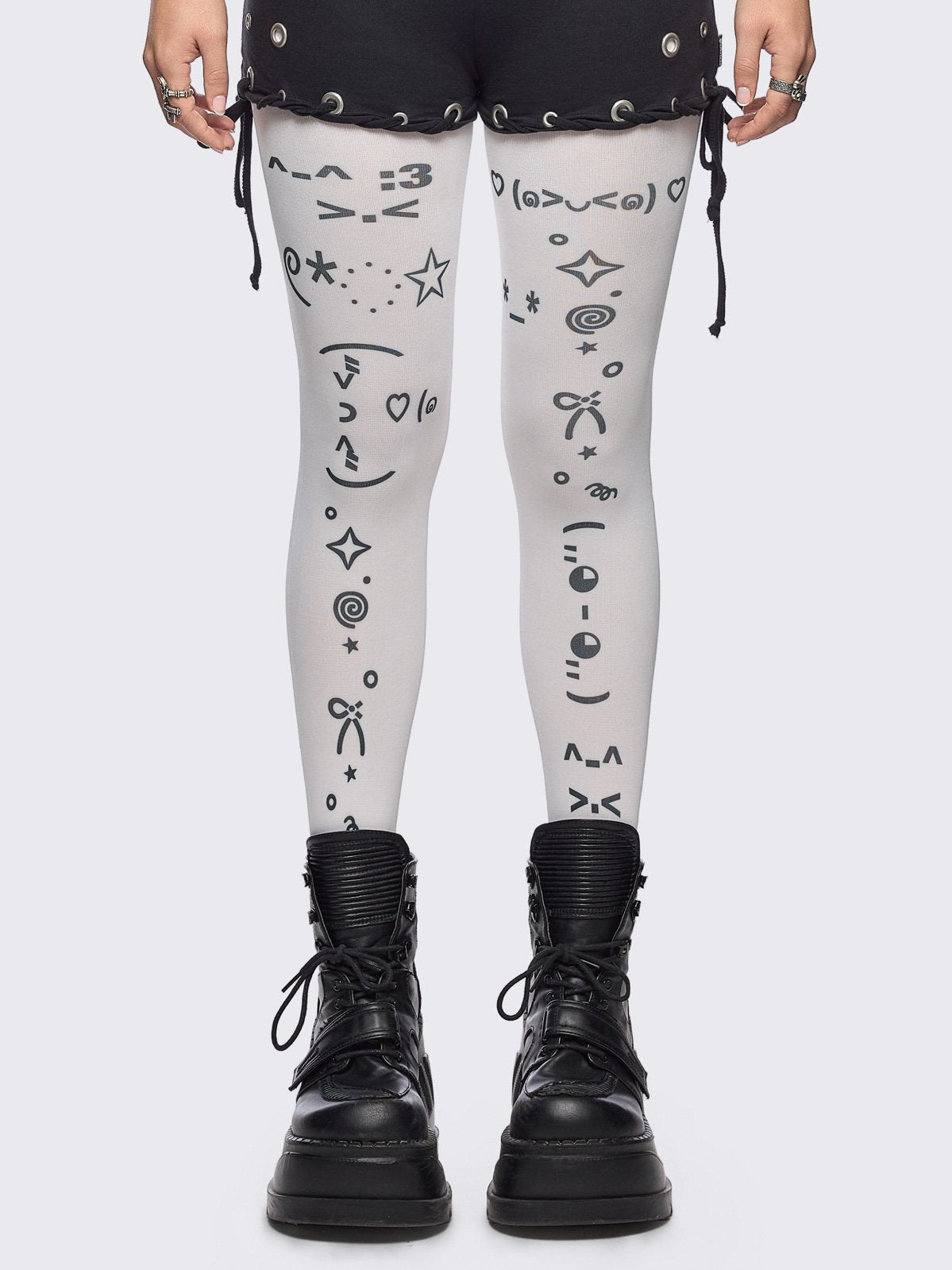 White opaque tights with kaomoji ASCII-style print.