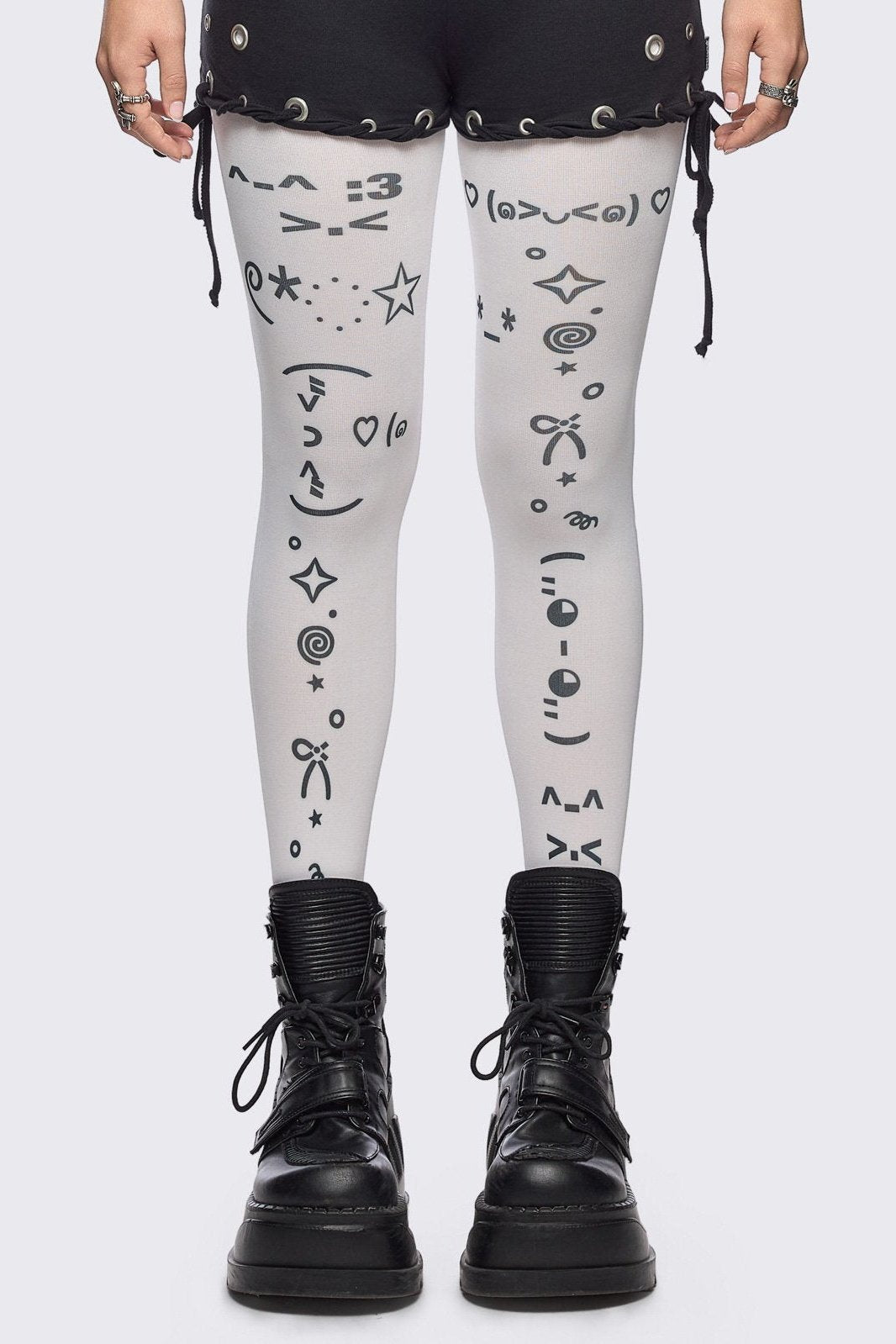 White opaque tights with kaomoji ASCII-style print.