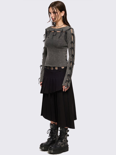 Black pleated asymmetric midi skirt with silver eyelet on waistband