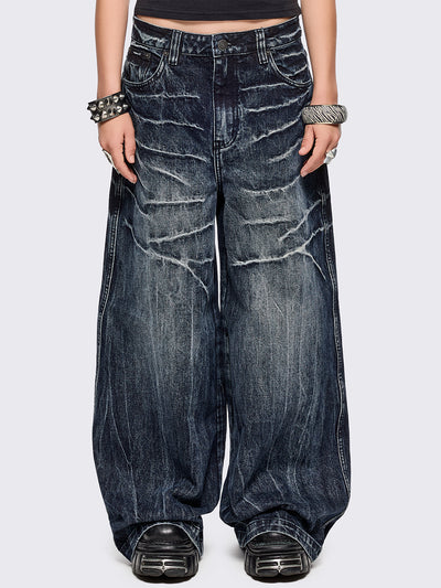 Blue washed wide leg baggy jeans featuring a grey overdye and distressed wrinkle-effect.