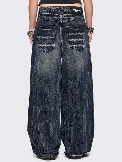 Blue washed wide leg baggy jeans featuring a grey overdye and distressed wrinkle-effect.