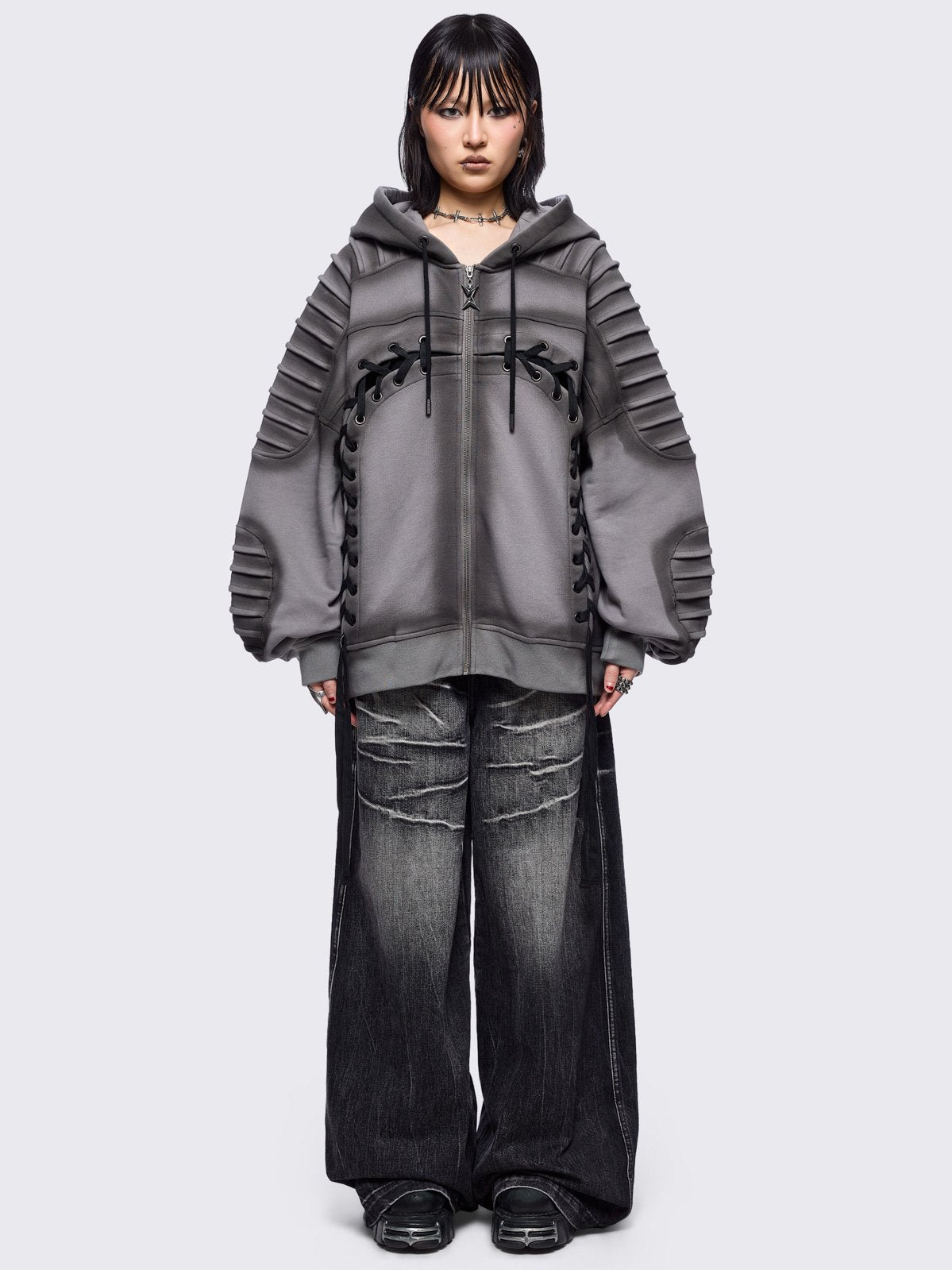 Grey washed zip up hoodie jacket featuring a moto pintuck panels and front lace corset details. 