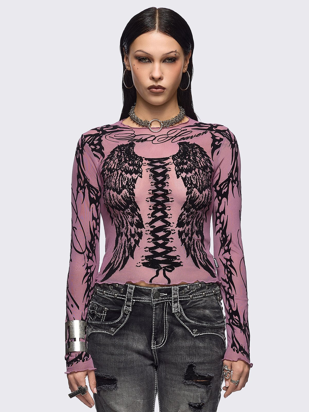 Pink mesh top with black winged corset and sigilism graphic print.