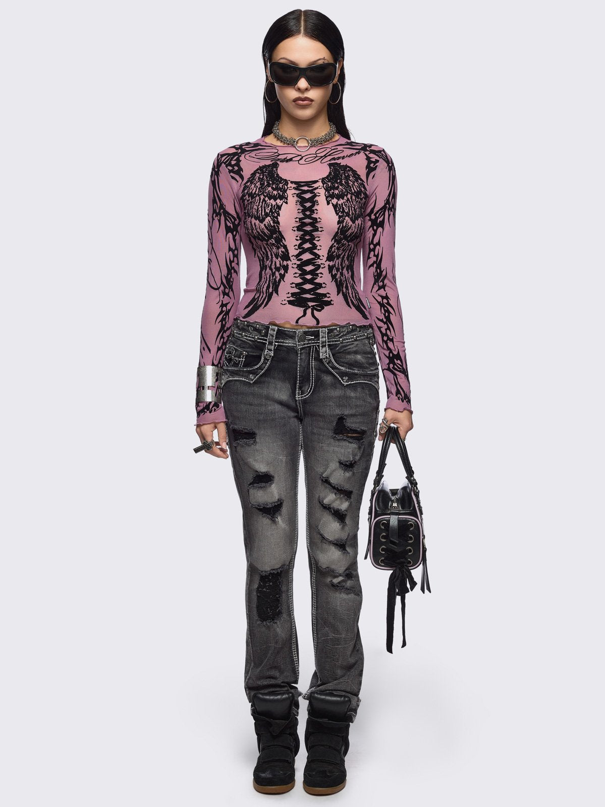 Pink mesh top with black winged corset and sigilism graphic print.