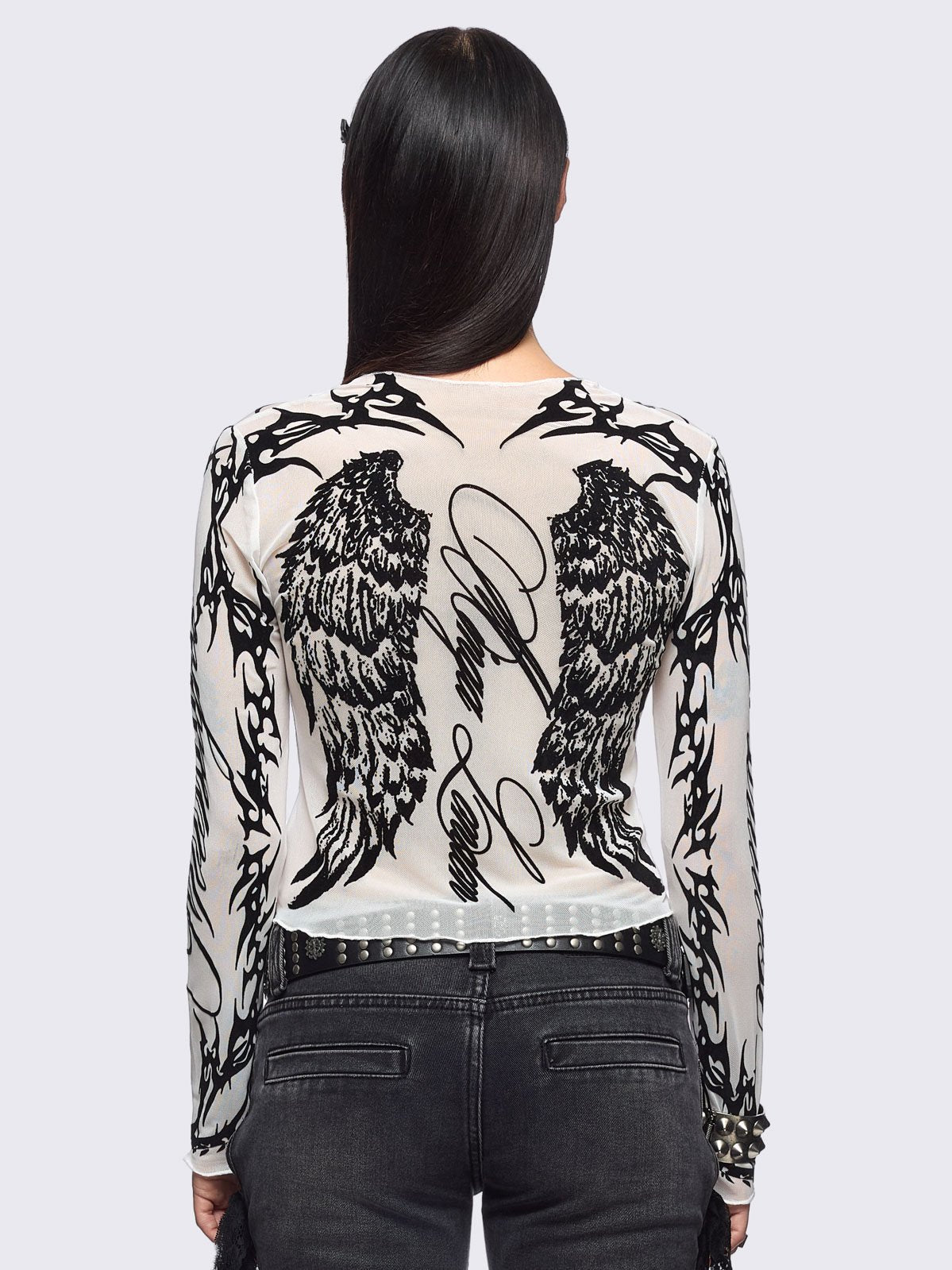 White mesh top with black winged corset and sigilism graphic print.