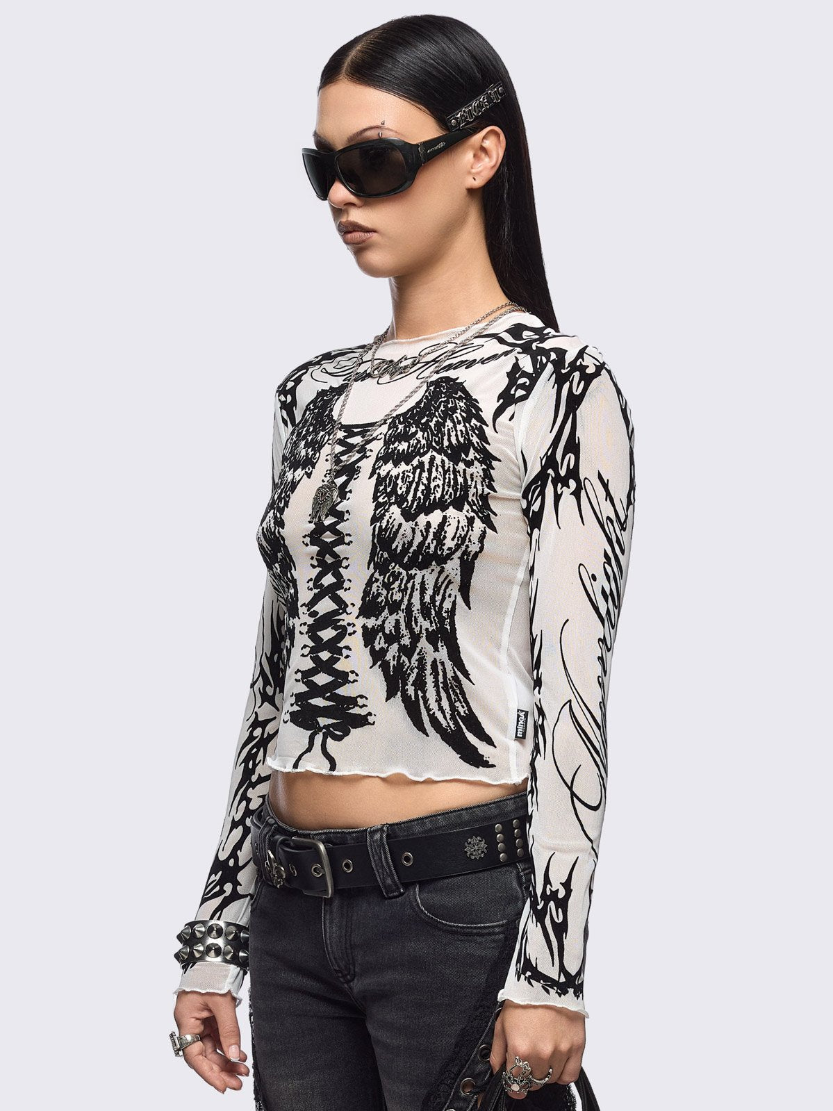 White mesh top with black winged corset and sigilism graphic print.