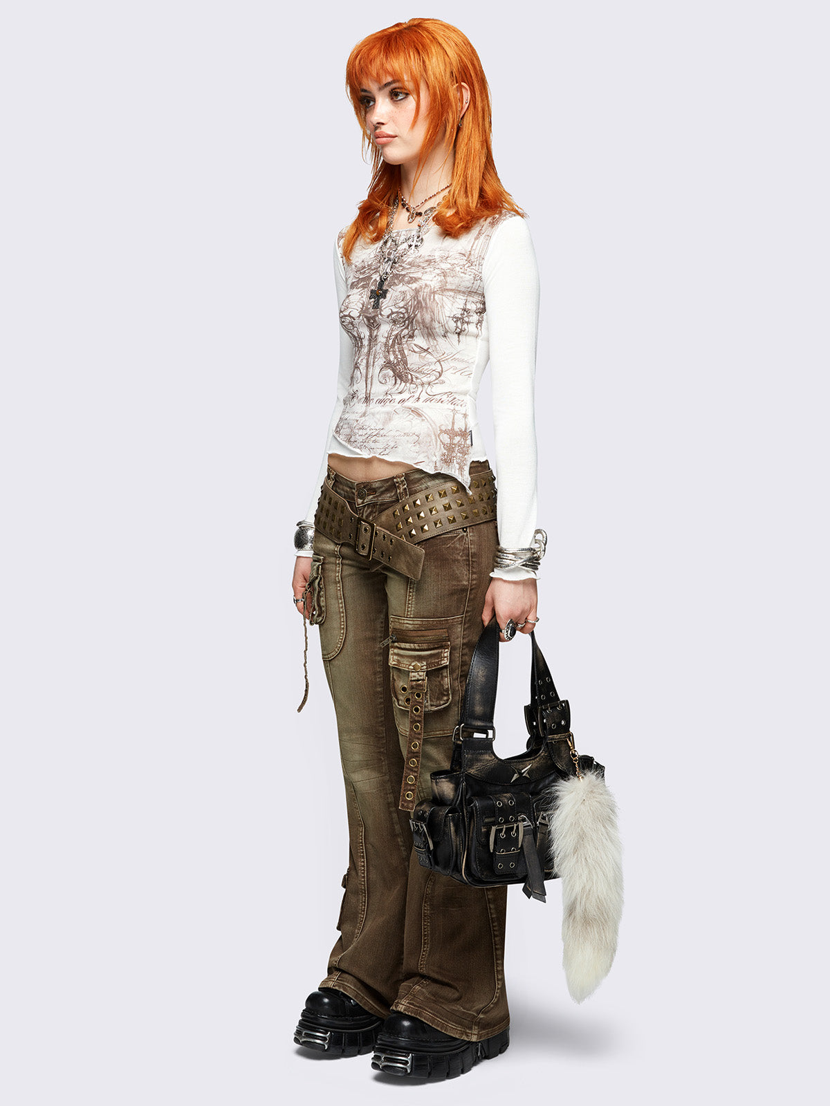 White asymmetric long sleeve top featuring winged dagger graphic front print.