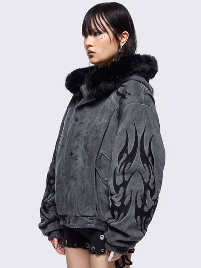 Grey washed denim bomber jacket featuring black sigilism patches and black faux fur hood.