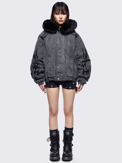 Grey washed denim bomber jacket featuring black sigilism patches and black faux fur hood.