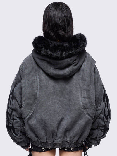 Grey washed denim bomber jacket featuring black sigilism patches and black faux fur hood.