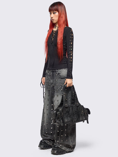 Black vegan leather shoulder bag with sigilism graphic embroidery and piercing, eyelet and stud details. 
Multiple pockets and two handles.