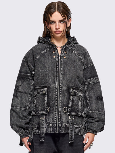 Black acid washed denim bomber jacket featuring boxy oversized fit, front flap pockets, buckle straps, eyelets, metal hardware and seams details.