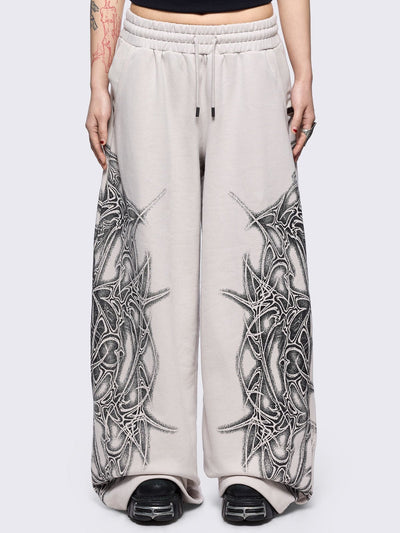 Grey wide leg sweatpants featuring a black sigilism graphic side print.