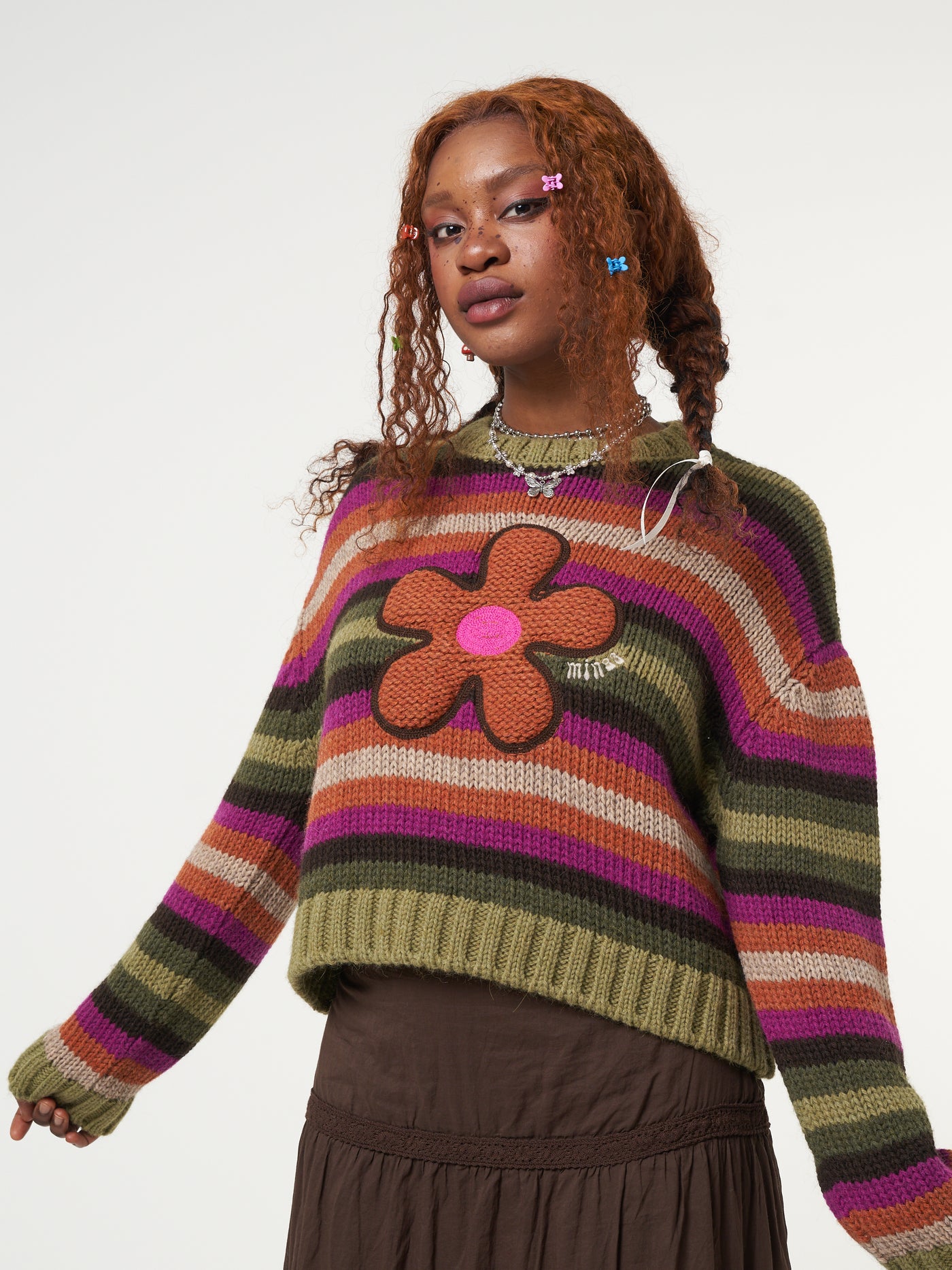 Knitted jumper in orange, pink, green and brown stripes featuring front Retro Flower embroidery