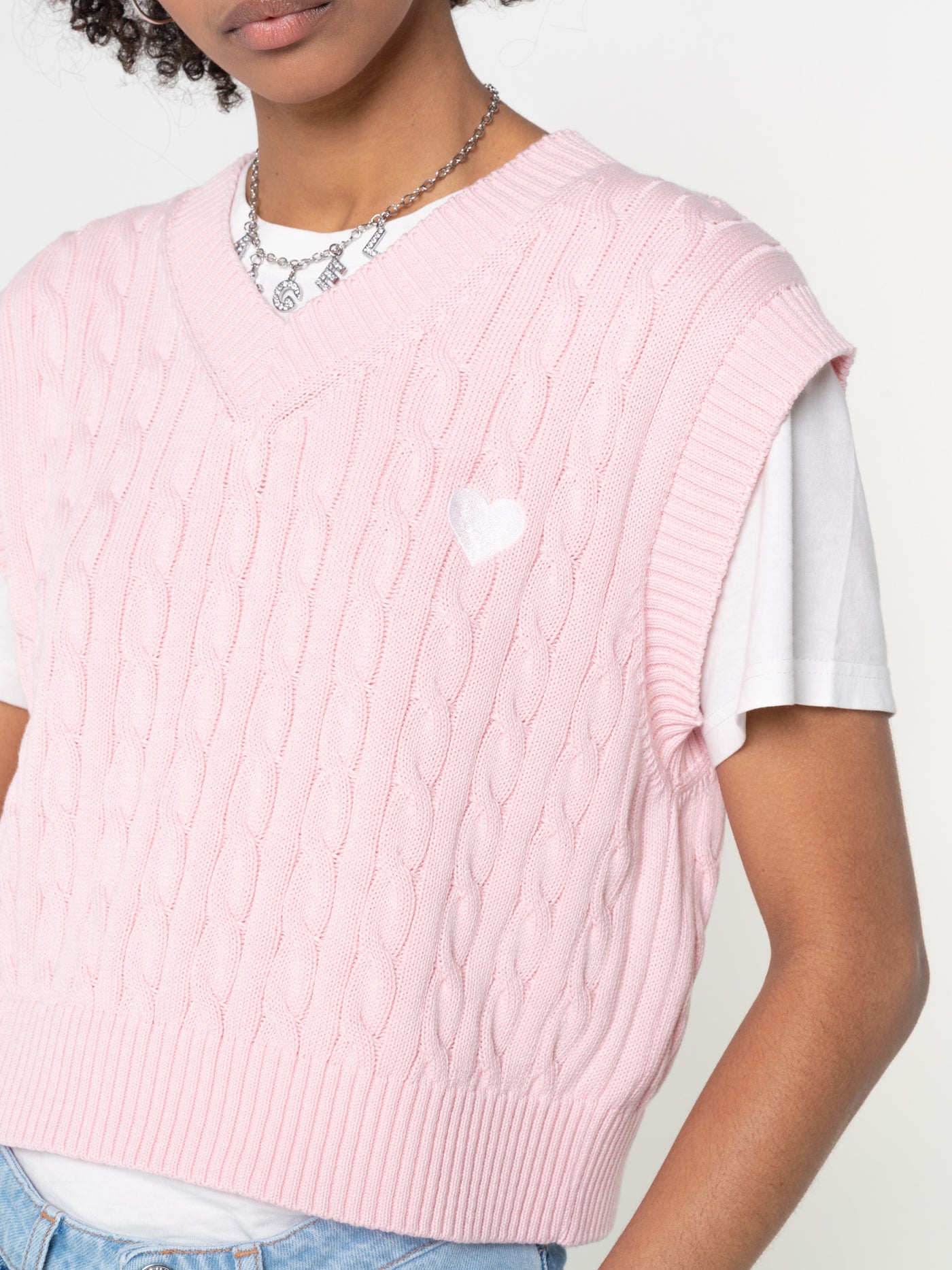Cable knitted sweater vest in pink with heart embroidery detail