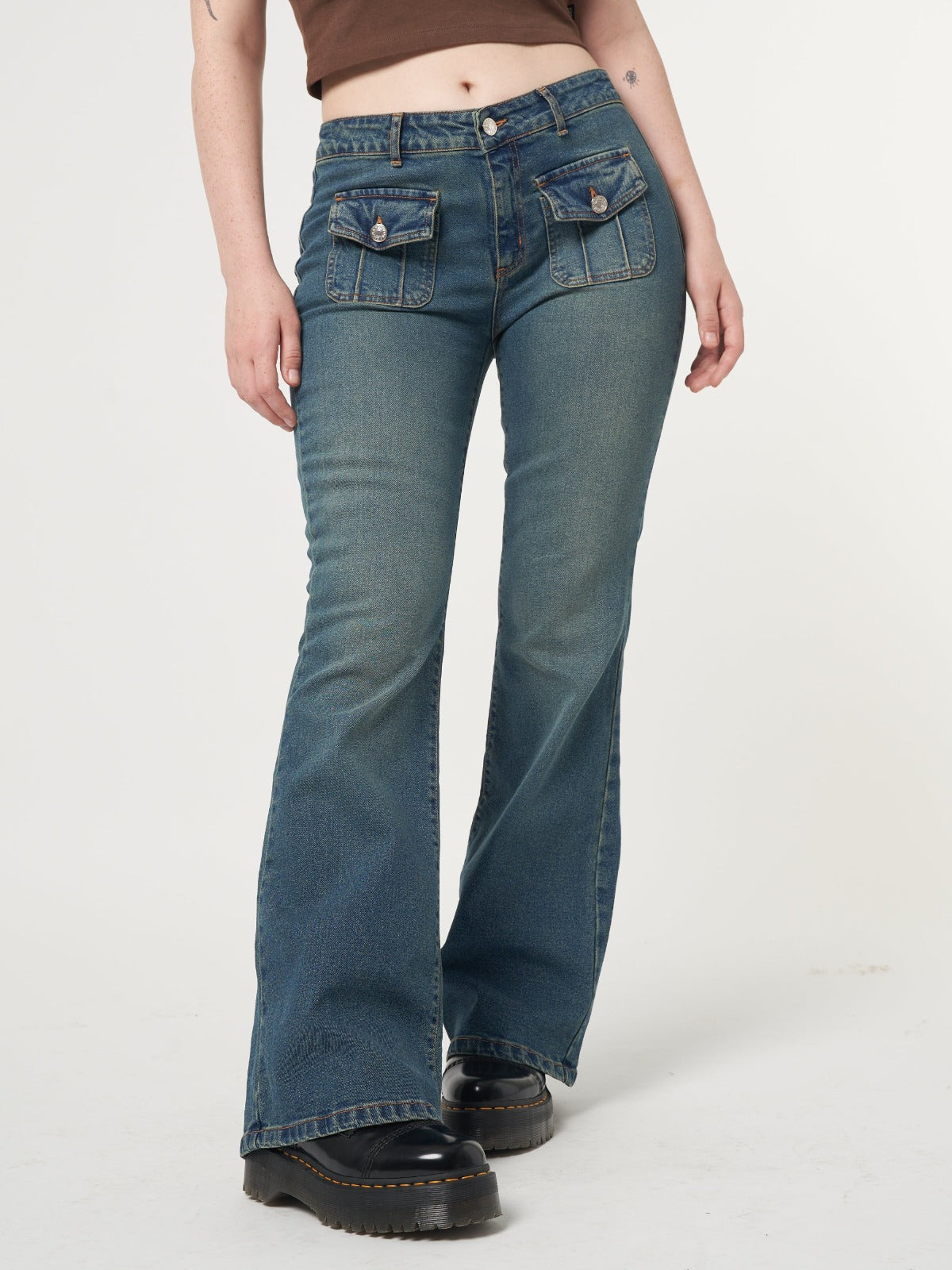 Low rise flare jeans with mini front pockets and vintage green overdye wash