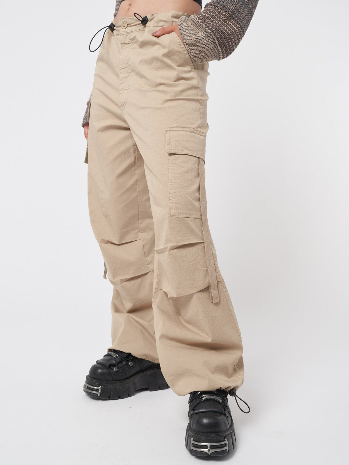 Beige tech cargo pants in parachute style with side utility pockets 