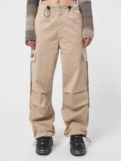 Beige tech cargo pants in parachute style with side utility pockets 
