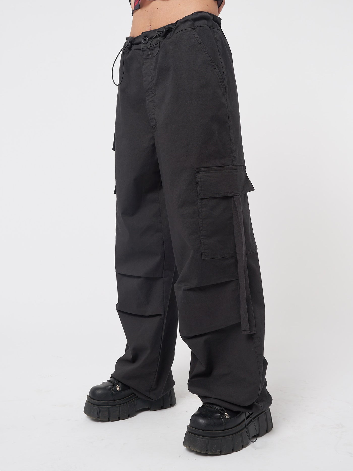 Black tech cargo pants in parachute style with side utility pockets 