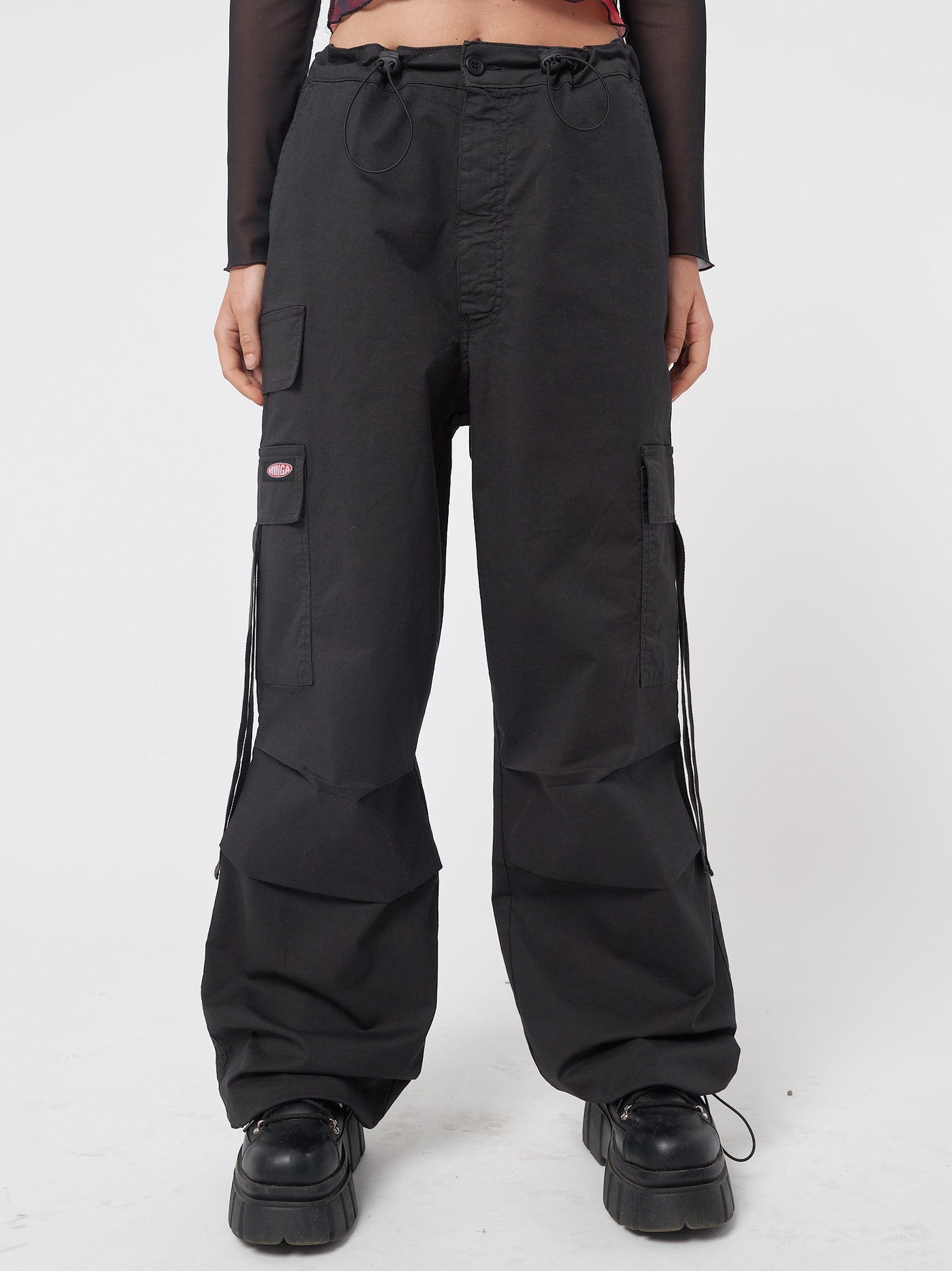 Black tech cargo pants in parachute style with side utility pockets 