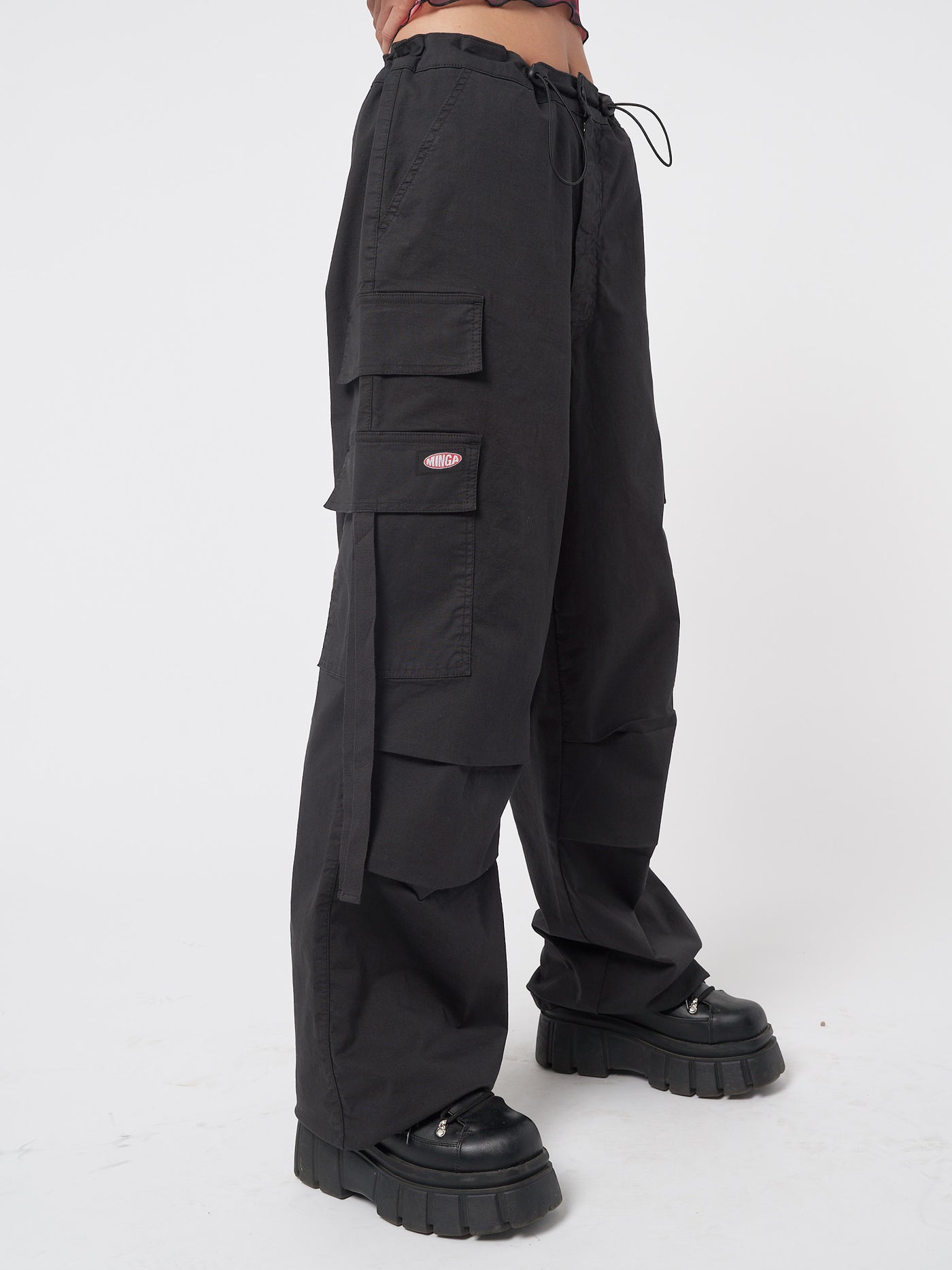 Black tech cargo pants in parachute style with side utility pockets 