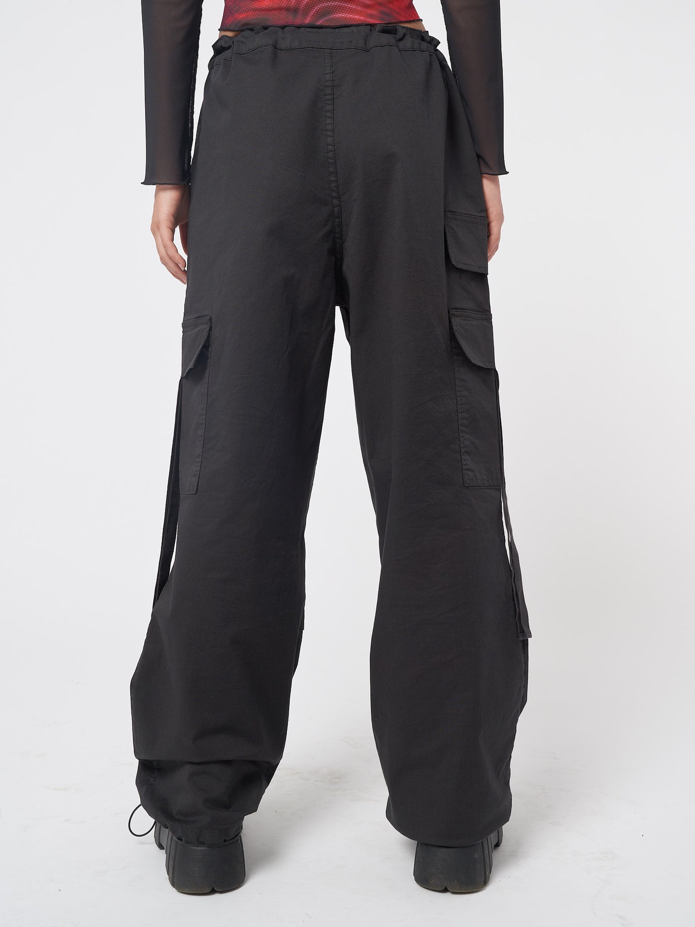 Black tech cargo pants in parachute style with side utility pockets 