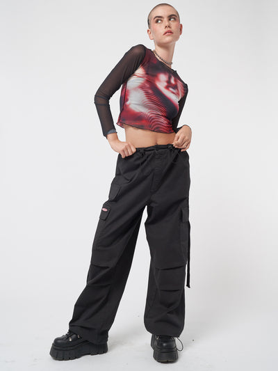 Black tech cargo pants in parachute style with side utility pockets 