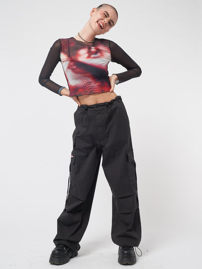 Black tech cargo pants in parachute style with side utility pockets 